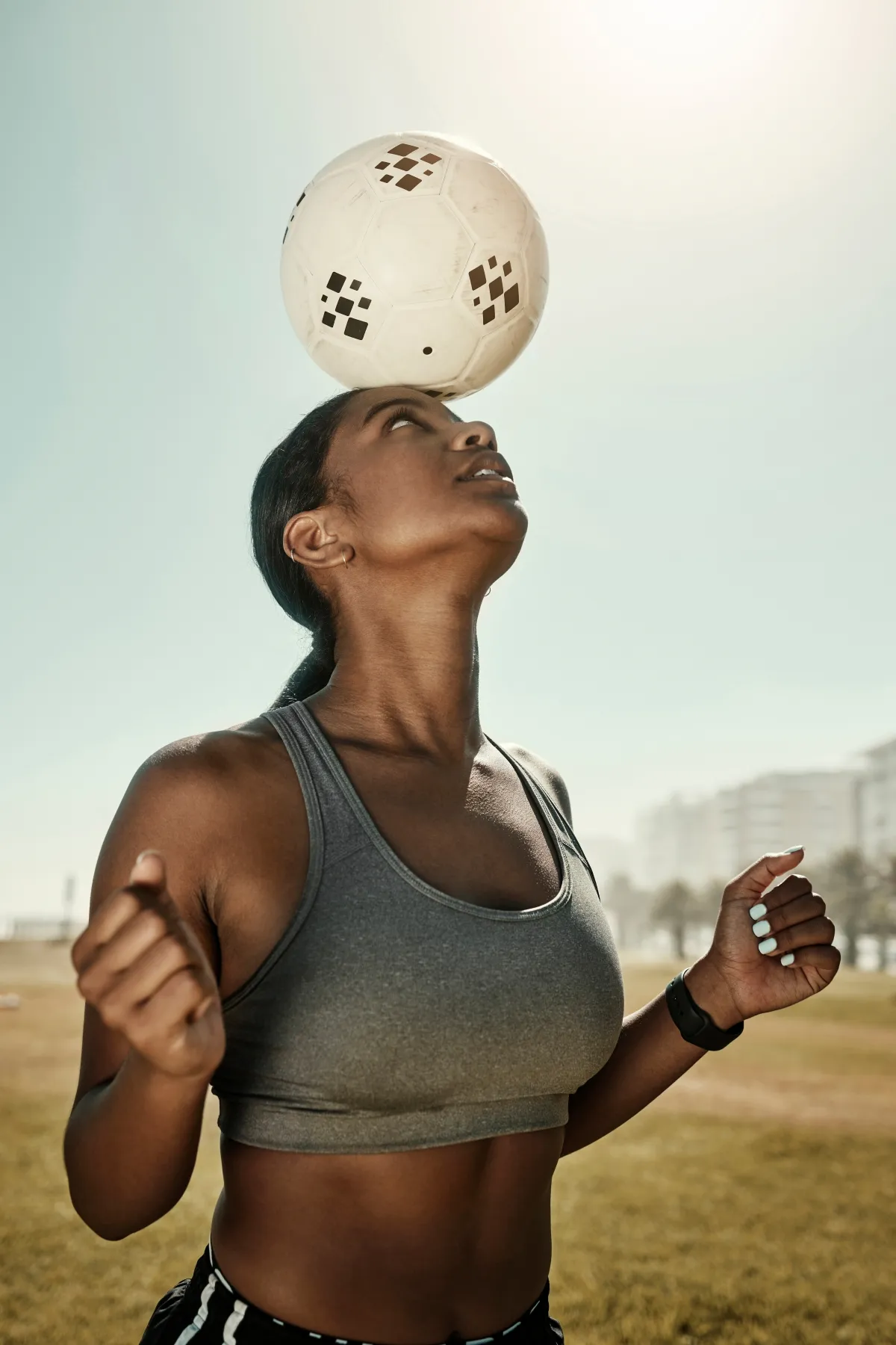 Football athlete balancing a ball during training